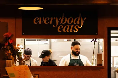 Everybody Eats kitchen team behind the service window